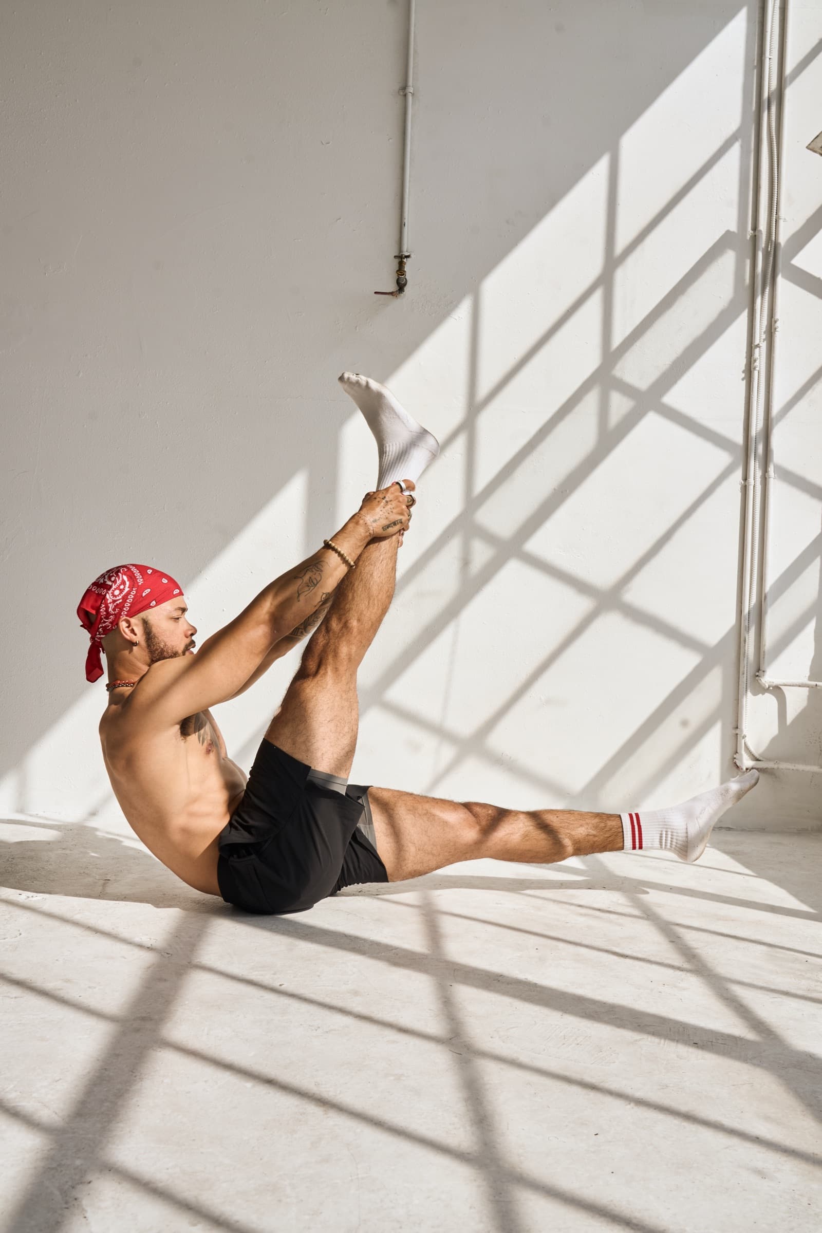 Greg in a seated Pilates pose